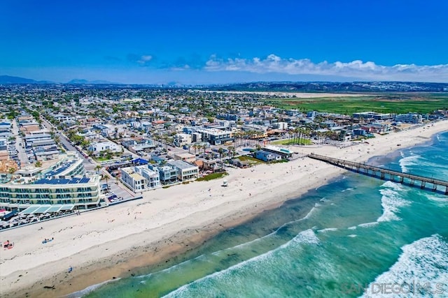 birds eye view of property featuring a beach view and a water view