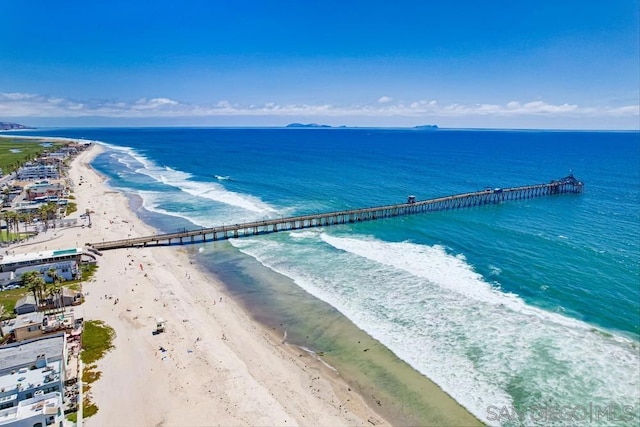 bird's eye view with a water view and a beach view