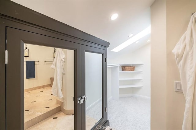 hallway featuring lofted ceiling