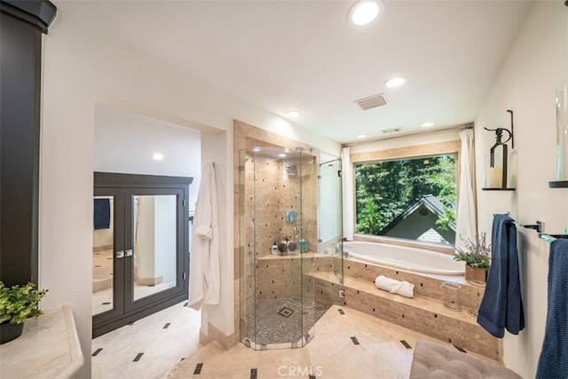 bathroom featuring separate shower and tub and tile patterned flooring