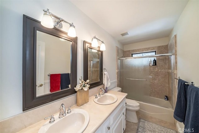 full bathroom featuring combined bath / shower with glass door, toilet, tile patterned floors, and vanity