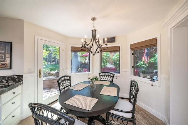 dining room with an inviting chandelier, light hardwood / wood-style flooring, and a wealth of natural light