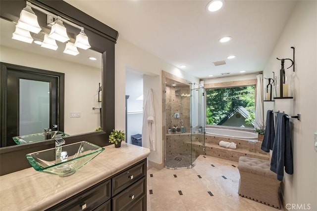 bathroom featuring vanity, shower with separate bathtub, and tile patterned floors