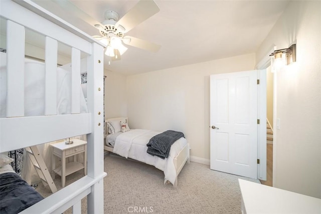 bedroom with ceiling fan and light colored carpet