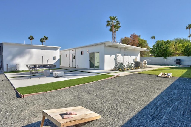 rear view of property featuring a patio area and central air condition unit