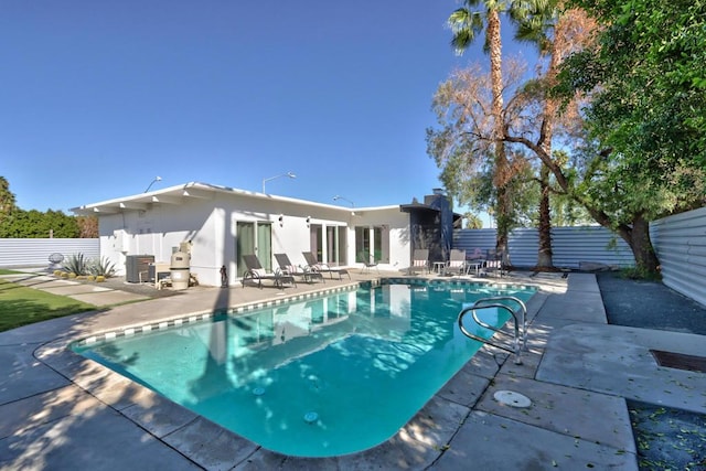 view of swimming pool featuring central AC and a patio