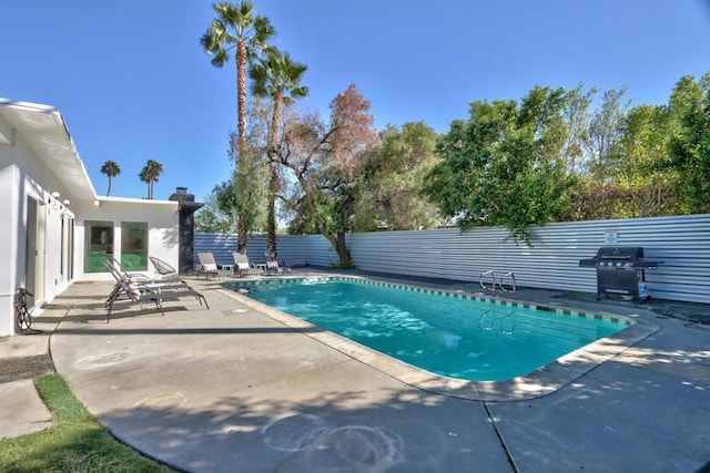 view of pool with a patio and grilling area