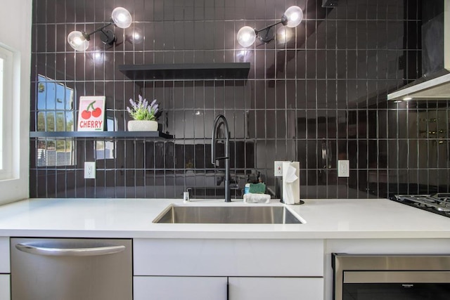 kitchen with tasteful backsplash, beverage cooler, dishwasher, wall chimney exhaust hood, and sink