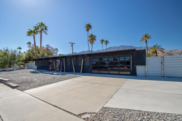 view of front of property featuring a garage and a mountain view