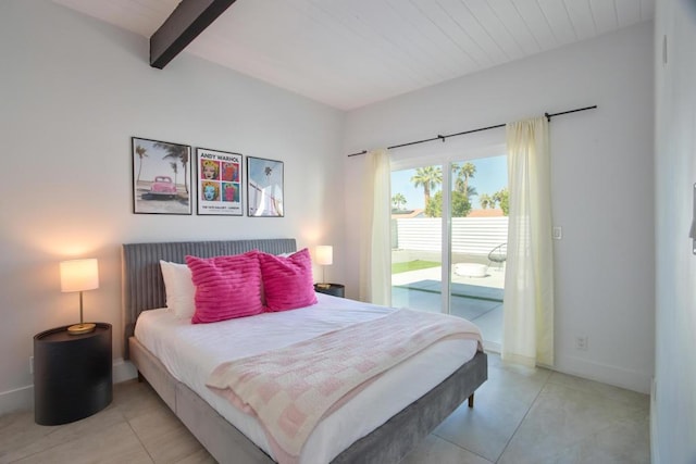 bedroom with beam ceiling and access to exterior