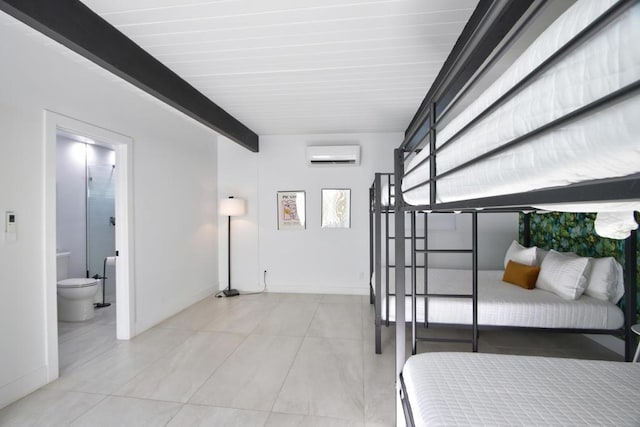 bedroom featuring an AC wall unit, beamed ceiling, and connected bathroom