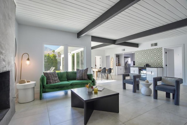 living room featuring beam ceiling and wine cooler