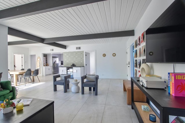 tiled living room with beamed ceiling