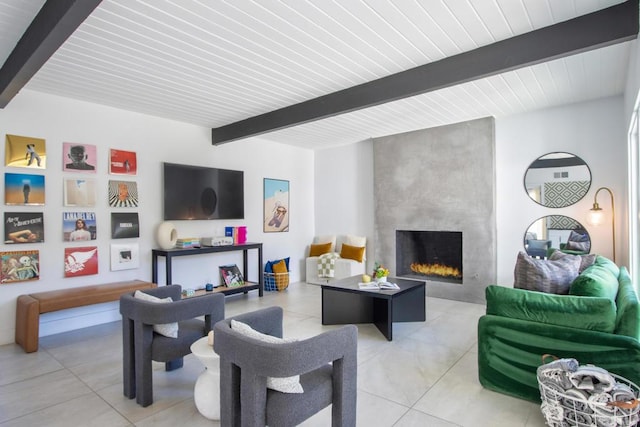 living room featuring a large fireplace and beamed ceiling