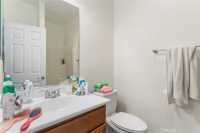 bathroom with toilet and vanity