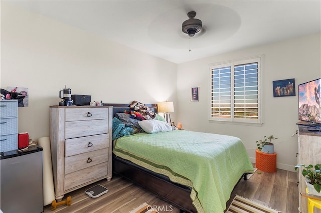 bedroom featuring ceiling fan and dark hardwood / wood-style floors