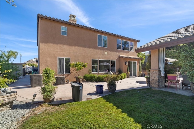 rear view of property featuring cooling unit, a patio, and a yard