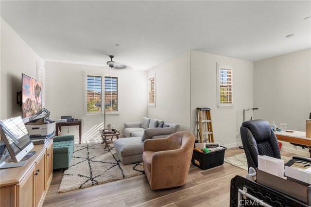 home office featuring ceiling fan and light hardwood / wood-style floors