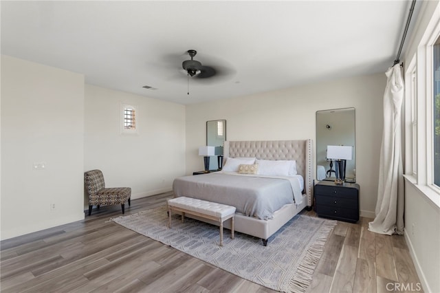 bedroom with ceiling fan and hardwood / wood-style flooring