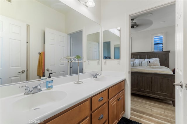 bathroom featuring ceiling fan, wood-type flooring, and vanity