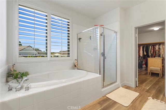 bathroom with separate shower and tub and hardwood / wood-style flooring