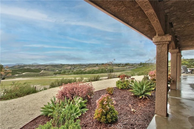 view of yard with a rural view and a patio area