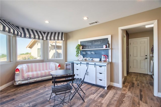 dining area featuring dark hardwood / wood-style floors and wine cooler