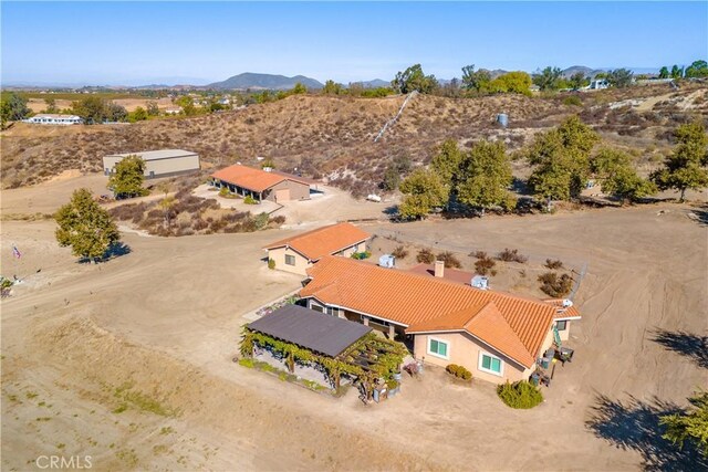 birds eye view of property with a mountain view