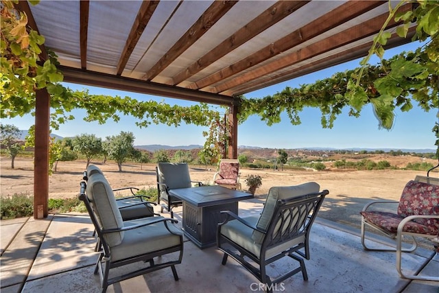 view of patio featuring a rural view and a mountain view