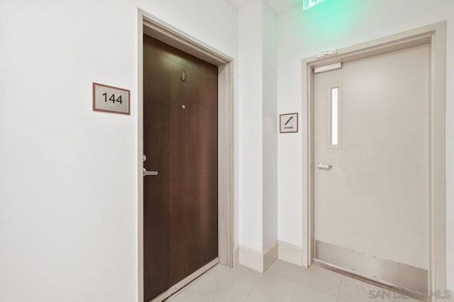 corridor featuring light tile patterned flooring