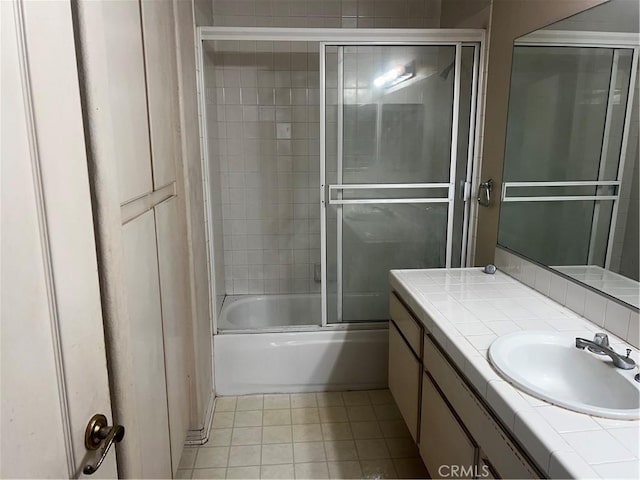 bathroom featuring vanity and shower / bath combination with glass door