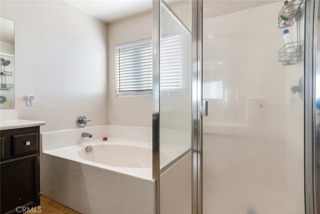 bathroom with vanity, tile patterned flooring, and plus walk in shower