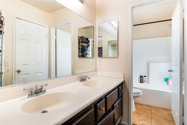 bathroom featuring tile patterned floors, toilet, vanity, and a tub