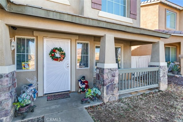 view of exterior entry featuring a porch