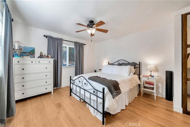 bedroom with ceiling fan and light hardwood / wood-style flooring