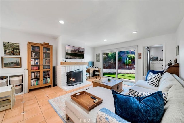 living room featuring a fireplace and light tile patterned flooring