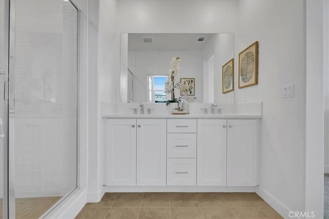bathroom featuring walk in shower, tile patterned floors, and vanity