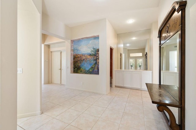 hallway with light tile patterned floors and french doors