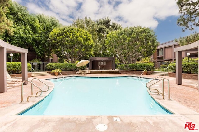 view of swimming pool featuring a patio area