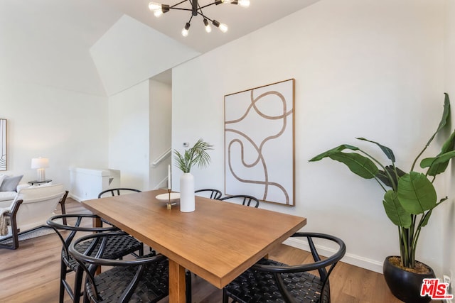 dining space featuring an inviting chandelier and light hardwood / wood-style floors