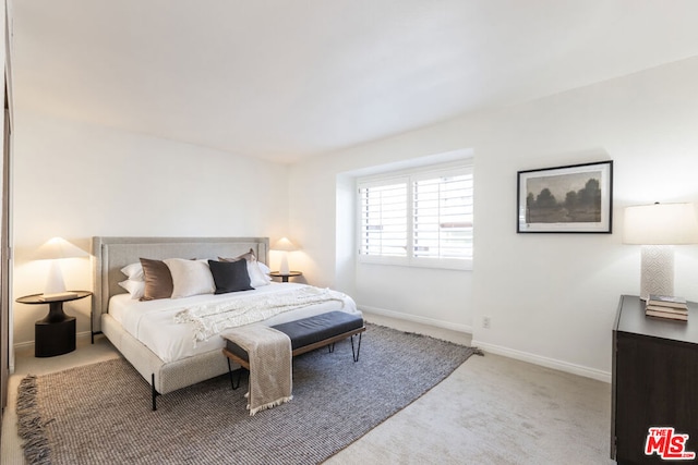 bedroom featuring light colored carpet