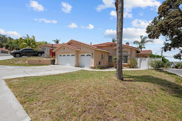 mediterranean / spanish-style house featuring a garage and a front yard