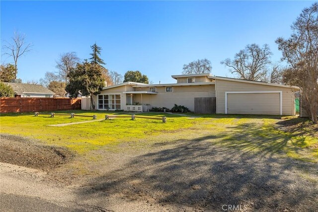 single story home with a garage and a front yard