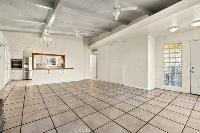 unfurnished living room featuring beamed ceiling, ceiling fan with notable chandelier, and light tile patterned flooring