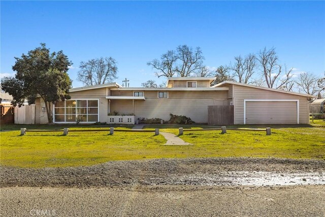 single story home with a front yard and a garage