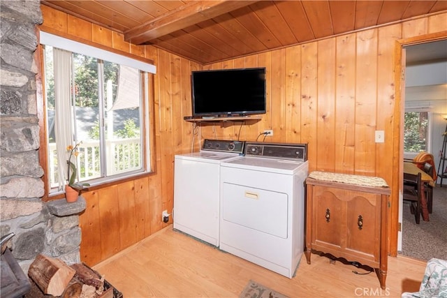 washroom featuring separate washer and dryer, wood walls, wood ceiling, and light wood-type flooring