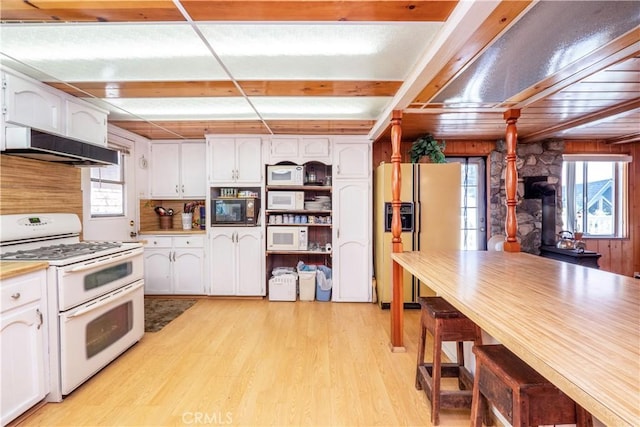 kitchen with white cabinetry, wooden walls, ventilation hood, white appliances, and light wood-type flooring