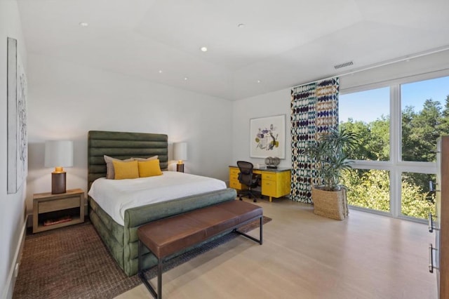 bedroom with multiple windows and light wood-type flooring