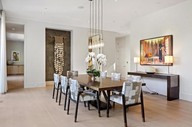 dining space featuring light hardwood / wood-style floors