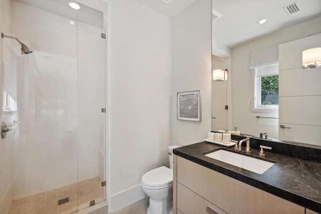 bathroom featuring toilet, vanity, and walk in shower